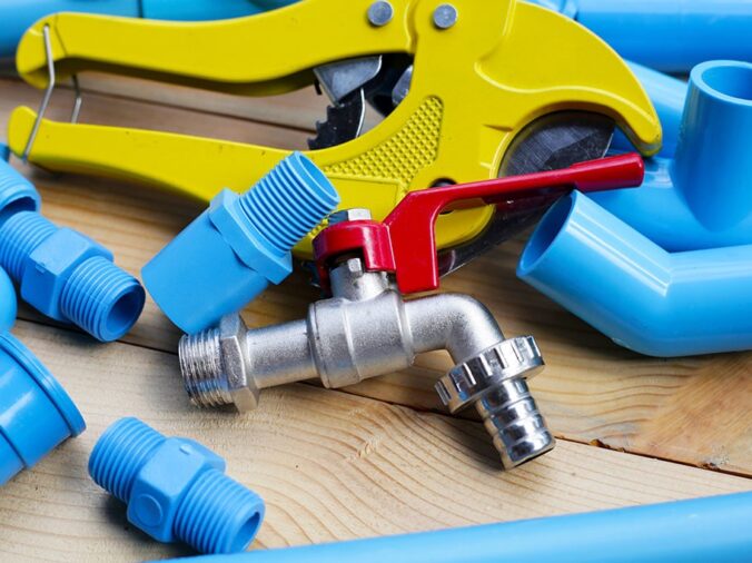 blue PVC fittings and a PVC cutting tool